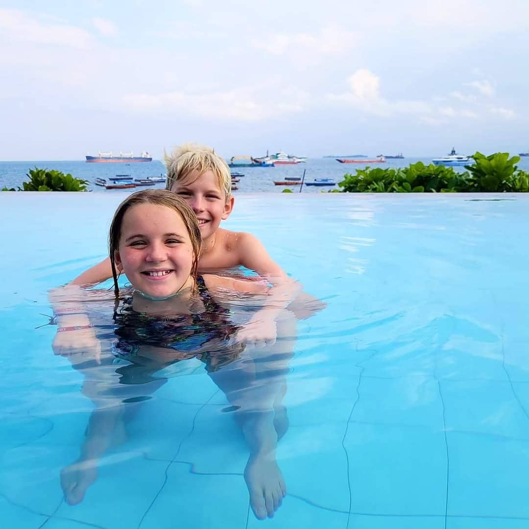 Children swimming in an infinity pool overlooking the Indian Ocean in Zanzibar