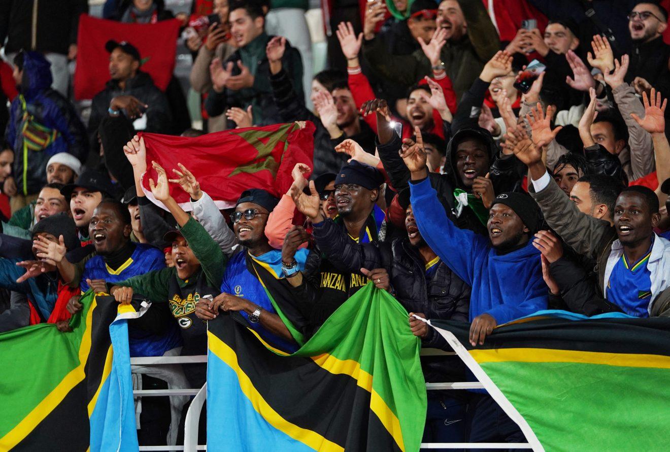 Tanzanian football fans celebrating with flags at an AFCON match