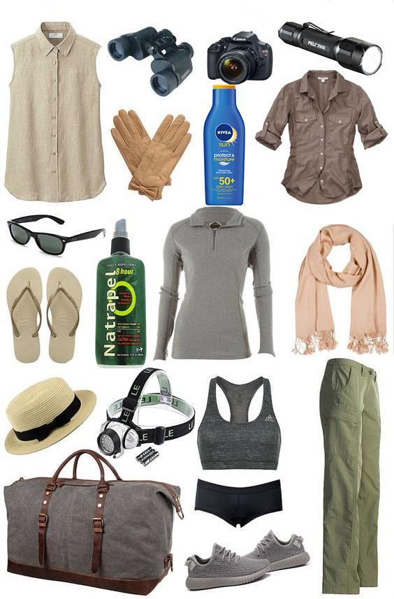 Trekking packing flat lay with fleece, headlamp, gloves, sunscreen, hiking trousers, sunglasses and duffel bag