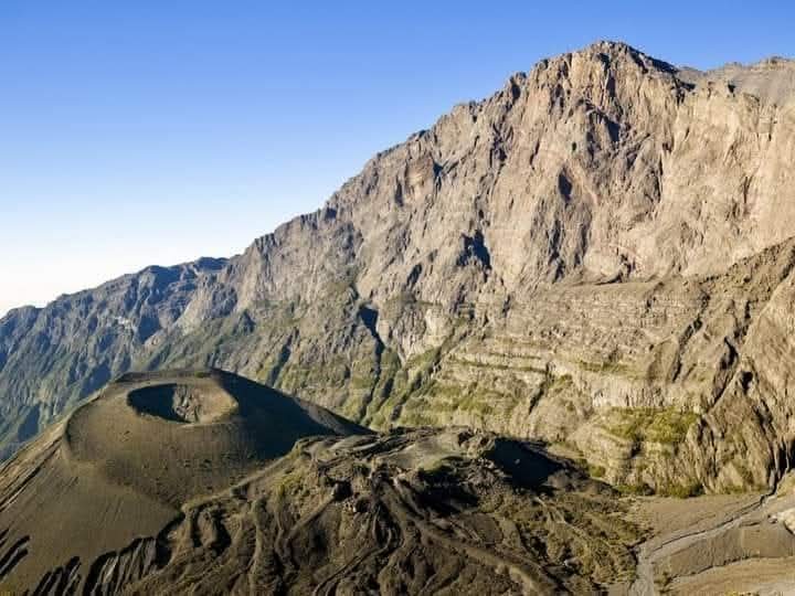 The dramatic ash cone and cliffs inside Mount Meru's crater